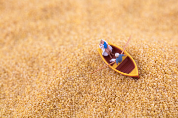 Miniature the boat in the world's millet ocean