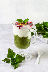 Delicious dessert with a layer of yogurt, nettle smoothie and honeysuckle jam. Dessert is served in...