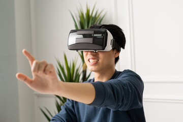 portrait of asian man using virtual reality glasses