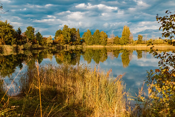 Beautiful autumn or indian summer view with reflections in a pond near Aholming, Bavaria, Germany