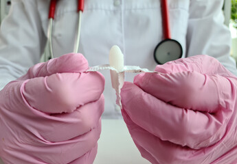 Doctor proctologist holding in hands antiinflammatory suppository for hemorrhoids closeup