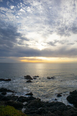 Fototapeta na wymiar Sunset on the ocean with rocks