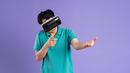 image of asian man wearing virtual reality glasses on purple background