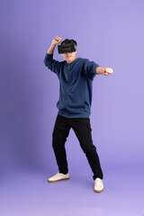 image of asian man wearing virtual reality glasses on purple background