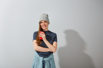 Isolated portrait of smiling girl with red coffee cup.