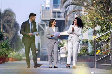 Business colleagues discussion outside office building.