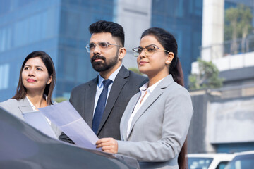 Group of businesspeople going through a report at work