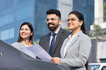 Group of businesspeople going through a report at work