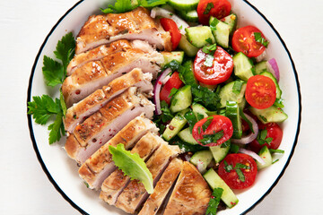 Salad with chicken meat. Fresh vegetable salad with chicken breast. Meat salad with chicken fillet and fresh vegetables on plate.