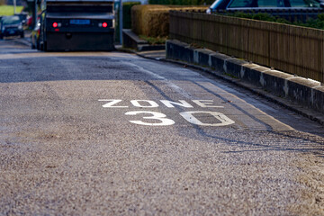 Obraz premium Close-up of road marking speed limit zone 30 kilometers per hour at urban road at City of Zürich district Seebach on a sunny winter day. Photo taken January 31st, 2023, Zurich, Switzerland.