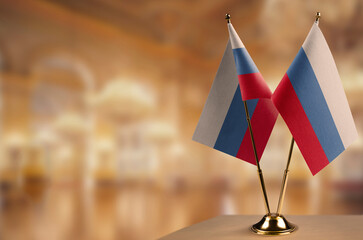 Small flags of the Russia on an abstract blurry background