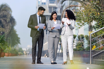 Fototapeta premium Business colleagues discussion outside office building.