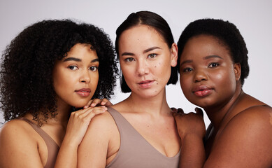 Portrait, beauty and diversity with woman friends in studio on a gray background together for skincare. Face, makeup and natural with a female model group posing to promote support or inclusion