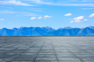 Empty square floor and green mountain with sky clouds background