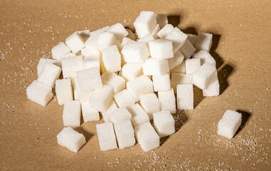 Refined sugar pieces heap, beet natural sweet cubes, lumps on craft kraft paper