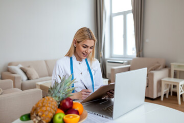 Female nutritionist giving consultation to patient. Making diet plan. Young woman visiting nutritionist in weight loss clinic