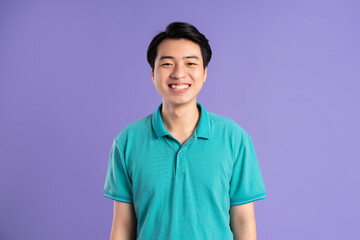 portrait of asian man posing on purple background