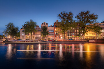 Fototapeta na wymiar Amsterdam Canals with bridge and dutch houses, Netherlands
