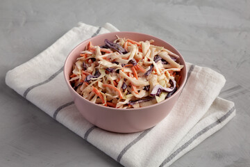 Homemade Classic Southern Coleslaw in a pink Bowl, side view.