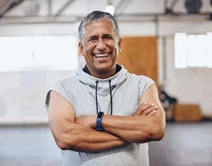 Fotobehang Gym, fitness and portrait of old man with smile and crossed arms for motivation, wellness and cardio workout. Muscles, healthy body and face of senior male after training, exercise and sports goals © S Fanti/peopleimages.com
