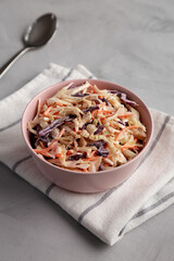 Homemade Classic Southern Coleslaw in a pink Bowl, side view.