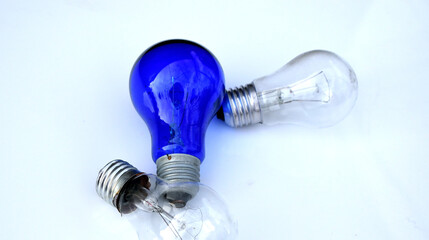 2 light bulbs and a blue medical lamp on a white background