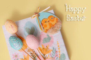 Easter decor, decoration for Easter - napkins for food and artificial eggs in pink, yellow and blue on a yellow background