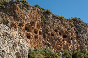 Fototapeta na wymiar Ruins of the rock tombs of the ancient city, in the mountains of Turkey, Antalya