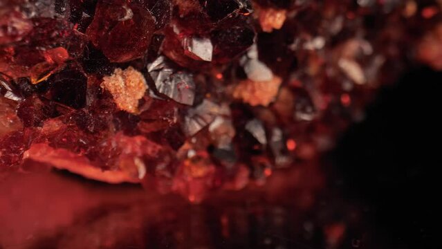 Radiant macro shot of golden citrine quartz crystal aglow against dark background. Smooth panning and macro lens for intricate surface details.
