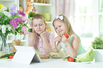 little brother and sister looking at tablet