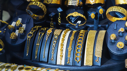 Jewelry shop window with a huge selection of gold jewelry bracelets, chains