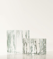 Two cold frozen natural ice cube transparent glass podium on white counter in sunlight on white...