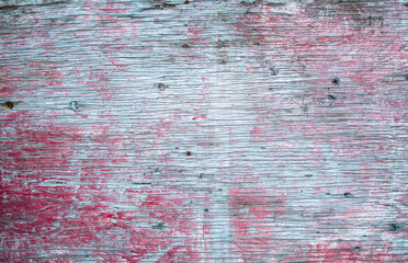Imagen horizontal de una madera vieja con textura pintada de blanco y rojo desgastada por el tiempo 