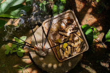 Burning incense sticks with auyrveda medical herbs on natural plate  top view selective focus effect in Sri Lanka
