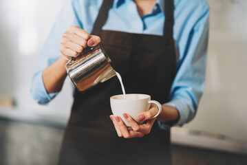 Professional barista making coffee at cafe, Small business owner preparing hot drink for customer.