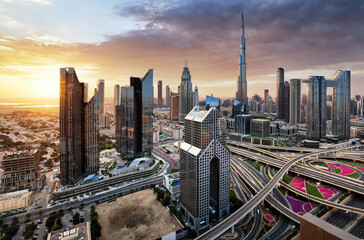 Fototapeta na wymiar Dramatic sunrise over Dubai skyline panorama with Burj Khalifa and luxury skyscrapers, United Arab Emirates