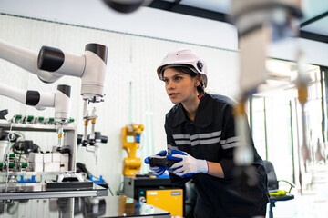 Engineer programming robot in robotics research facility