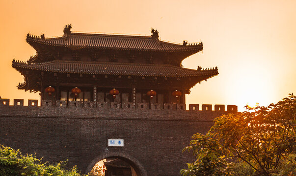 The sunset at Dong Guan ancient city wall, the chinese characters in the pictures translated as "Dong Guan", the name of this place. The chinese characters on top are chinese poems.