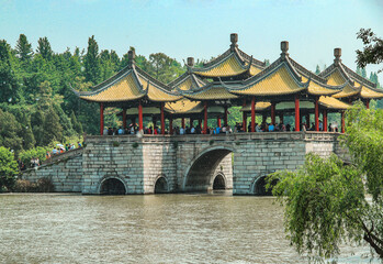 Wuting Bridge in Slender West Lake in sunny days. Chinese characters on the bridge translated as...