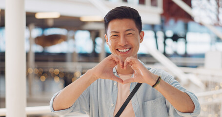 Shopping, hands in heart and face of Asian man with smile for shopping, retail and consumerism....