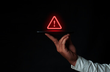 Hand holding smartphone with warning triangle sign for error alert and maintenance concept. Data protection from hackers