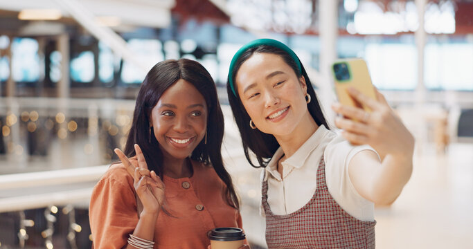 Phone selfie, women and friends with peace sign at mall taking pictures for social media. Bokeh, hand gesture and girls taking photo on mobile smartphone for profile picture or happy memory together.