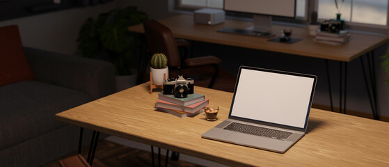 Laptop white screen mockup with camera, coffee cup, book and decor plant on wood table