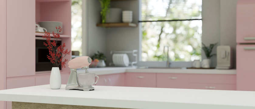 Side view of white kitchen tabletop with dough mixer and copy space in trendy pink kitchen