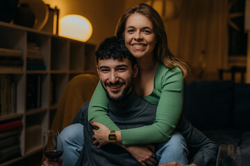 Woman is hugging her boyfriend from behind