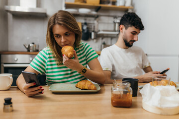 Distanced couple is having breakfast together