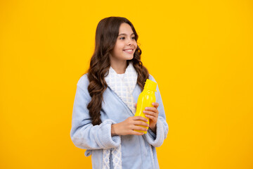 Teen girl with water from plastic bottle on isolated background, copy space. Kid girl care body hydration. Active leisure and water balance.