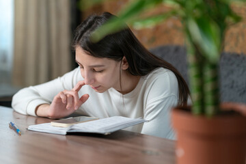 freelancer working at home sitting with a notebook and phone at the table