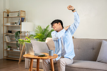 Businessman in casual is sitting comfortable sofa to stretching