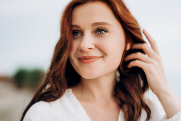 Fototapeta premium pregnant girl with brown hair on the seashore